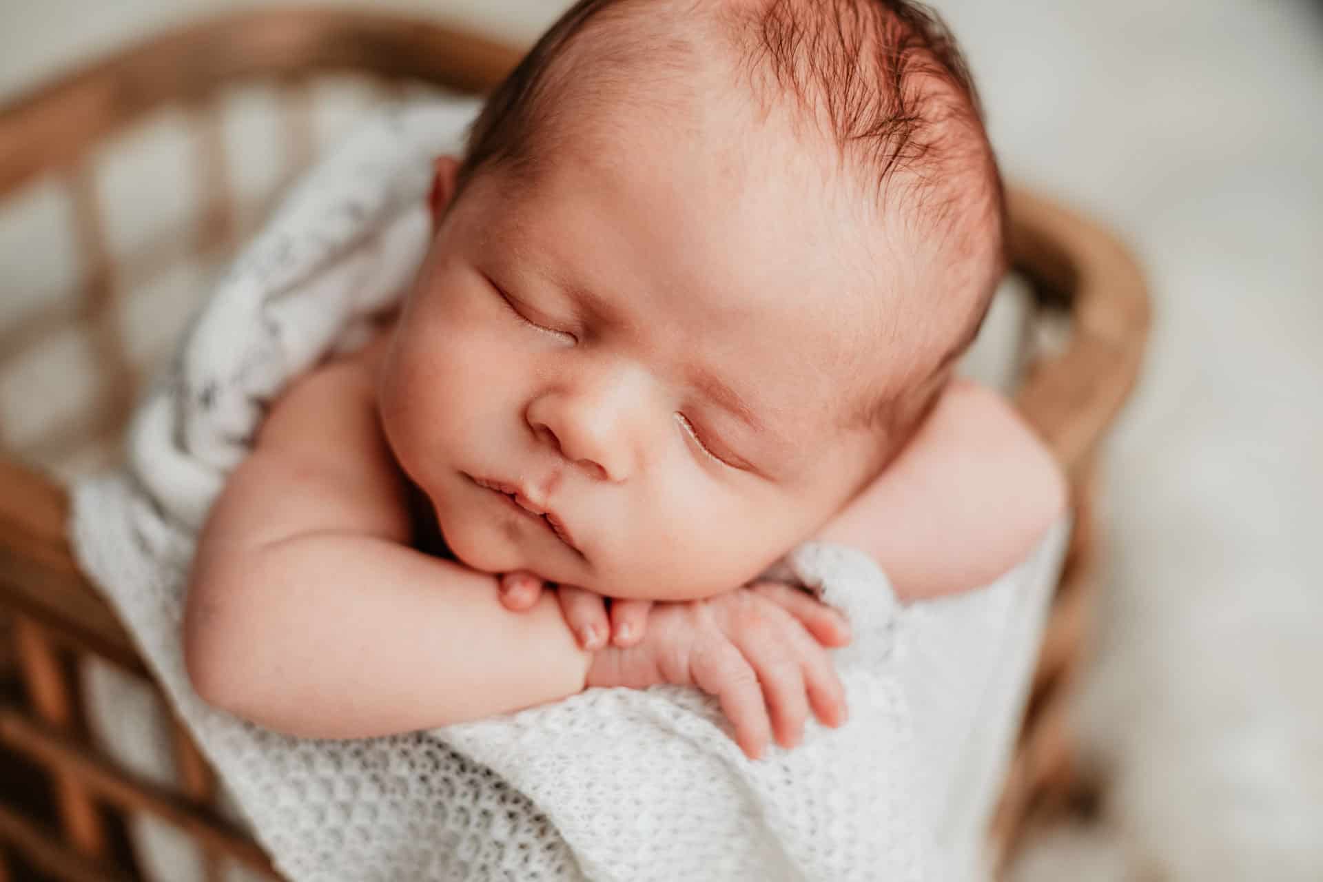 Newborn baby in photo prop