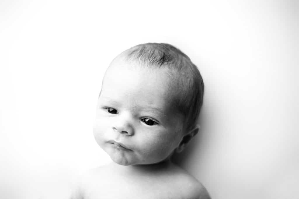 newborn baby looking away image in black and white